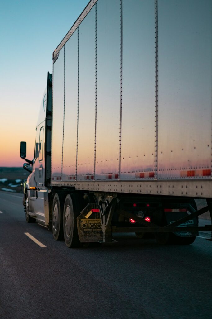 Truck on road at sunset